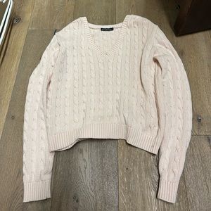 This pink Brandy Melville sweater is one size fits all